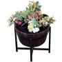 Flower pots in wooden barrel on metal stand