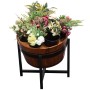 Flower pots in wooden barrel on metal stand