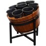 Flower pots in wooden barrel on metal stand