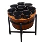 Flower pots in wooden barrel on metal stand